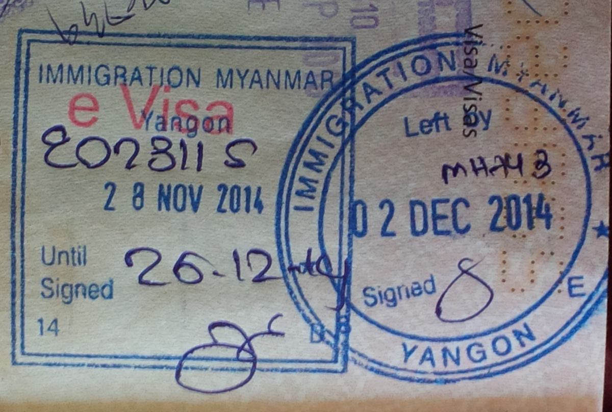 Entry and exit stamps inked across a passport page